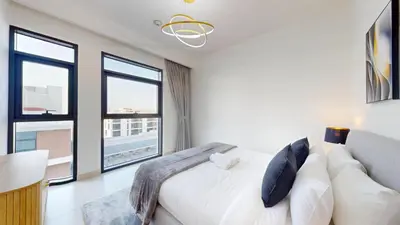 a bedroom with a white bed and large windows at Vacationer l Vibrant 2 Bed l Dubai Hills Mall l Free Pool, Gym in Dubai