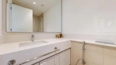 a bathroom with a sink and a mirror at Vacationer l Vibrant 2 Bed l Dubai Hills Mall l Free Pool, Gym in Dubai