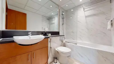 a bathroom with a sink and a toilet and a shower at Vacationer l Peaceful 2 Bed l Sheikh Zayed Road l The Greens in Dubai