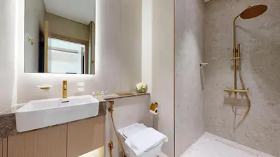 a bathroom with a sink and a shower and a toilet at Locations l Aesthetic 1 Bed l Own Private Pool l Circle Mall in Dubai