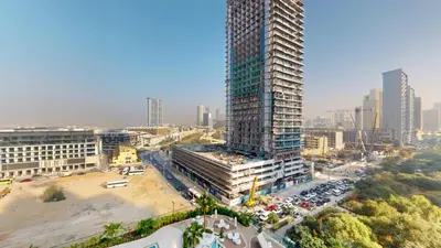 an overhead view of a city with a tall building at Locations l Aesthetic 1 Bed l Own Private Pool l Circle Mall in Dubai