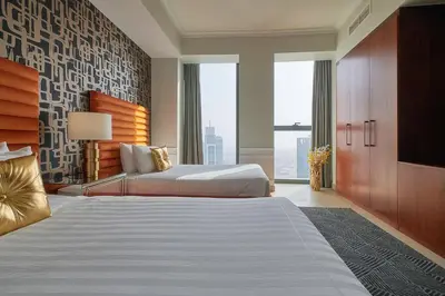 a bedroom with a large bed and a large window at Signature Luxury Apartments Facing Burj Khalifa in Dubai