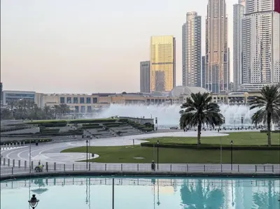 a view of a city with a fountain in the background at Signature Luxury Apartments Facing Burj Khalifa in Dubai