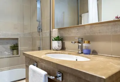 a bathroom with a sink and a bath tub at Signature Luxury Apartments Facing Burj Khalifa in Dubai