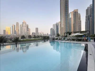 a large swimming pool in a city with tall buildings at Signature Luxury Apartments Facing Burj Khalifa in Dubai