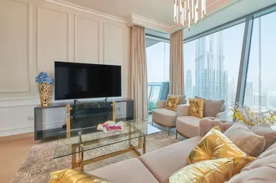 a living room with a flat screen tv and a couch at Signature Luxury Apartments Facing Burj Khalifa in Dubai