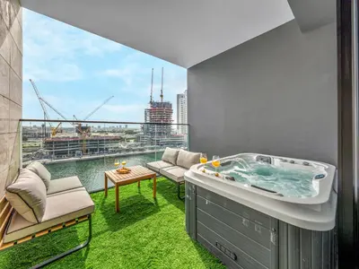 a jacuzzi tub on a balcony with a view at Spacious Studio with Balcony & Jacuzzi Trillionaire Residences, Business Bay in Dubai