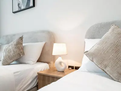 a guest bedroom with a bed and a chair at Spacious Studio with Balcony & Jacuzzi Trillionaire Residences, Business Bay in Dubai