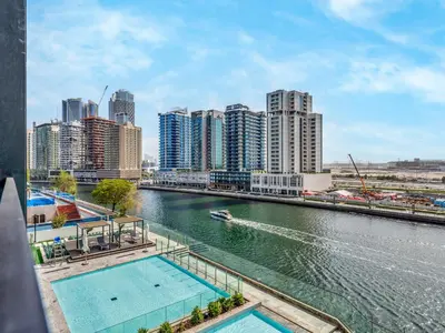 a view of a river in a city with buildings at Spacious Studio with Balcony & Jacuzzi Trillionaire Residences, Business Bay in Dubai