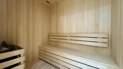 a sauna with a wooden bench in a room at Spacious Studio with Balcony & Jacuzzi Trillionaire Residences, Business Bay in Dubai