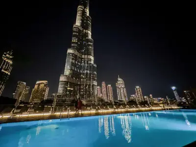 a view of a large city at night at Vogue Downtown Address Residence near Burj Khalifa and Dubai Mall, Two Bedroom Apartment with Balcony and Burj Khalifa view, Access to all Amenities in Dubai