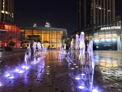 a water fountain in front of a building at night at Vogue Downtown Address Residence near Burj Khalifa and Dubai Mall, Two Bedroom Apartment with Balcony and Burj Khalifa view, Access to all Amenities in Dubai