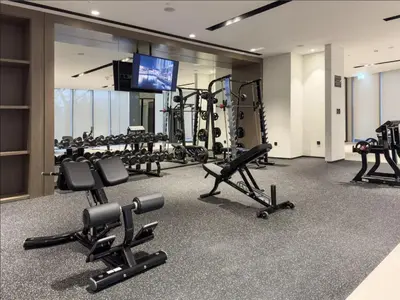 a gym with several treadmills and tread machines at Upscale Burj Vista Downtown Stays with Burj Khalifa View in Dubai