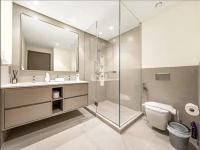 a bathroom with a shower and a toilet and a sink at Upscale Burj Vista Downtown Stays with Burj Khalifa View in Dubai