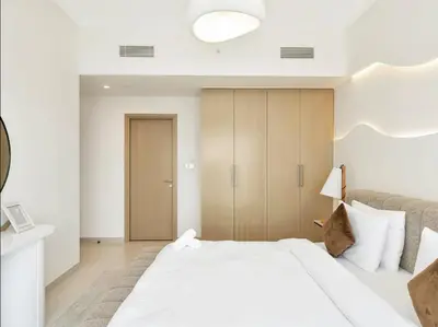 a bedroom with a large white bed and a closet at Upscale Burj Vista Downtown Stays with Burj Khalifa View in Dubai