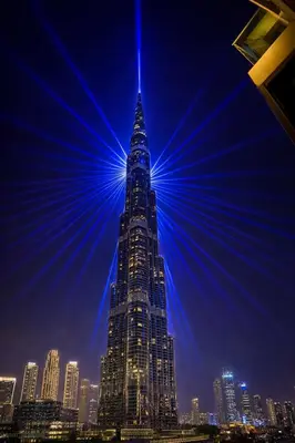 a tall building with a blue light on top of it at Upscale Burj Vista Downtown Stays with Burj Khalifa View in Dubai