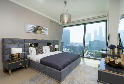 a bedroom with a large bed and a large window at Upscale Burj Vista Downtown Stays with Burj Khalifa View in Dubai