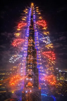a view of the empire state building lit up at night at Premium Burj Vista Downtown Apartments with Burj Khalifa View in Dubai