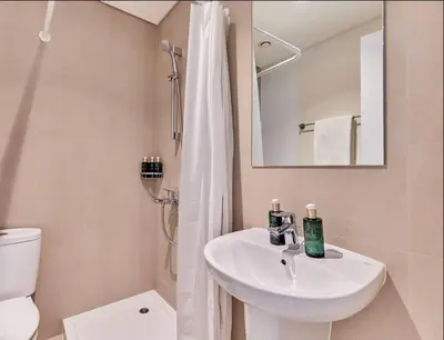 a bathroom with a sink and a toilet and a mirror at Premium Burj Vista Downtown Apartments with Burj Khalifa View in Dubai