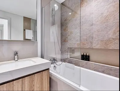 a bathroom with a sink and a glass shower at Spacious Luxury Apartments at Burj Vista with Direct Burj Khalifa Views in Dubai