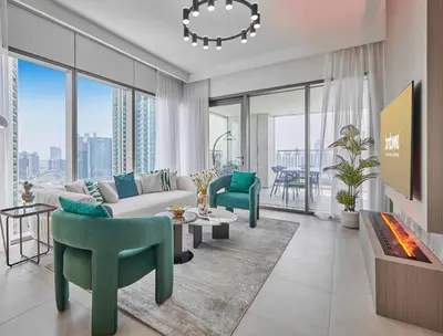 a living room with a couch and chairs and a fireplace at Spacious Luxury Apartments at Burj Vista with Direct Burj Khalifa Views in Dubai