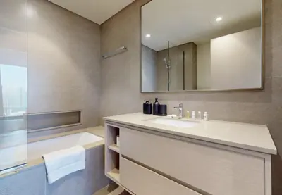 a bathroom with a sink and a tub and a mirror at Exclusive Burj Khalifa View Downtown Burj Vista Apartments in Dubai