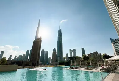 a large swimming pool in a city with buildings at Exclusive Burj Khalifa View Downtown Burj Vista Apartments in Dubai