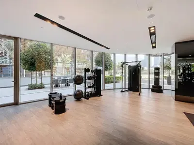a gym with a bunch of equipment in a room with windows at Exclusive Burj Khalifa View Downtown Burj Vista Apartments in Dubai