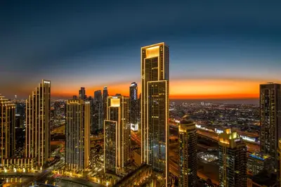 a city skyline at night with tall buildings at Vogue Downtown Address Residence near Burj Khalifa and Dubai Mall, Two Bedroom Apartment with Balcony and City Skyline view, Access to all Amenities in Dubai