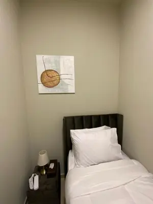 a bedroom with a bed and a table with a lamp at palm tree Jbr in Dubai