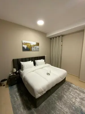 a bedroom with a large white bed in a room at palm tree Jbr in Dubai