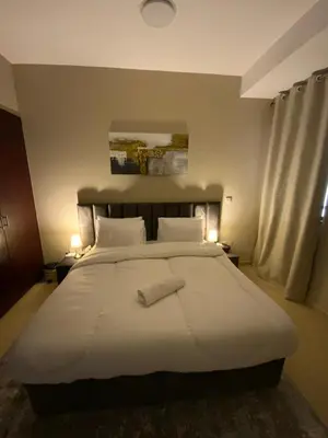 a bedroom with a large bed with two towels on it at palm tree Jbr in Dubai