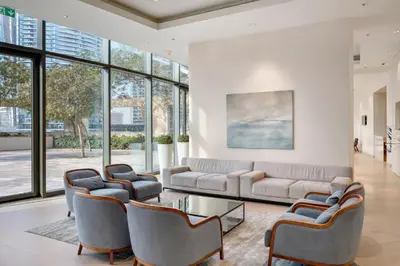 a living room with a couch and chairs and windows at Prime Burj Vista Residences with Burj Khalifa View in Dubai