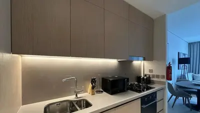 a kitchen with a sink and a stove top oven at Prime Burj Vista Residences with Burj Khalifa View in Dubai