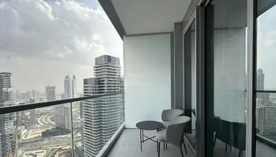 a room with a view of a city from a skyscraper at Prime Burj Vista Residences with Burj Khalifa View in Dubai
