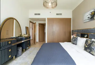 a bedroom with a large bed and a mirror at Prime Burj Vista Residences with Burj Khalifa View in Dubai