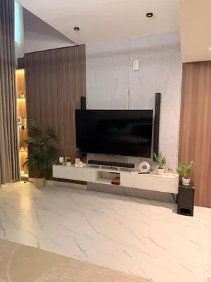 a living room with a large flat screen tv on a wall at Quiet Villa 3 Br in Dubai