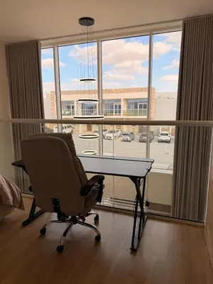 an office with a desk and a chair in front of a window at Quiet Villa 3 Br in Dubai