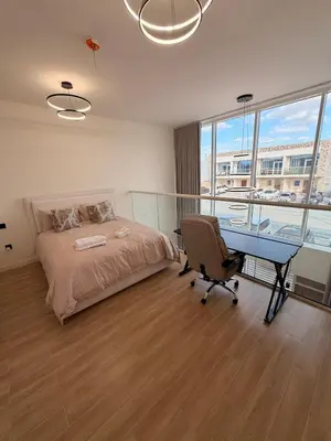 a bedroom with a bed and a desk and a desk at Quiet Villa 3 Br in Dubai