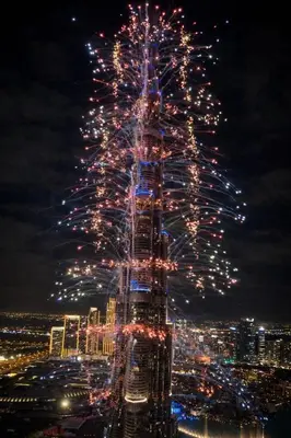 a lit up christmas tree on top of a building at Grand Burj Vista Downtown Apartment with Burj Khalifa View in Dubai