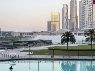 a view of a city with a fountain in the background at Grand Burj Vista Downtown Apartment with Burj Khalifa View in Dubai