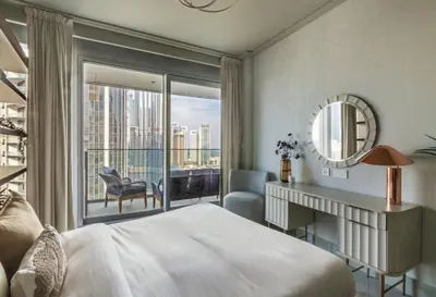 a bedroom with a large bed and a large window at Grand Burj Vista Downtown Apartment with Burj Khalifa View in Dubai