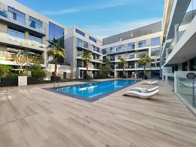 a swimming pool in the middle of a building at Elegant 1BR with Pool Gym & Burj Khalifa Views in Dubai