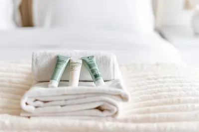 two toothbrushes in a holder on a bed at Skyz by Danube Chic 2BR with Balcony & Pool Access in Dubai