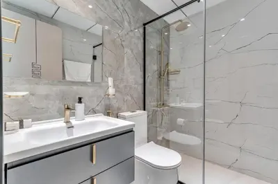 a bathroom with a sink and a toilet and a shower at Skyz by Danube Chic 2BR with Balcony & Pool Access in Dubai