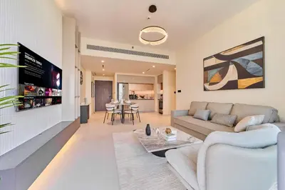 a living room with a couch and a table at Modern 1BR with Palm View Dubai Harbour in Dubai