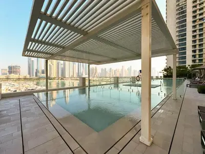 a large swimming pool with a canopy on a building at Modern 1BR with Palm View Dubai Harbour in Dubai