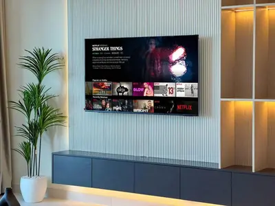 a tv hanging on a wall in a room at Modern 1BR with Palm View Dubai Harbour in Dubai