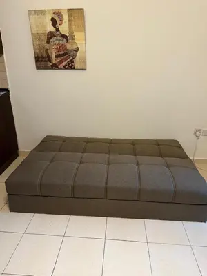 a large bed in a room with a picture on the wall at Modern 1BR in JVC, 2 Baths, Pool & Gym, Fully Equipped Kitchen in Dubai