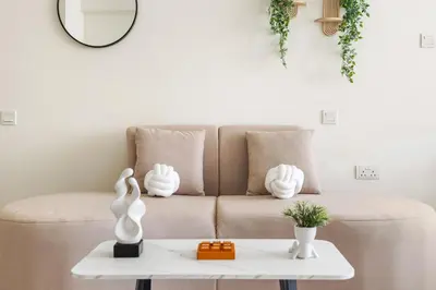 a living room with a couch and a table at Amazing Studio with Balcony & Marina Eye Views in Dubai